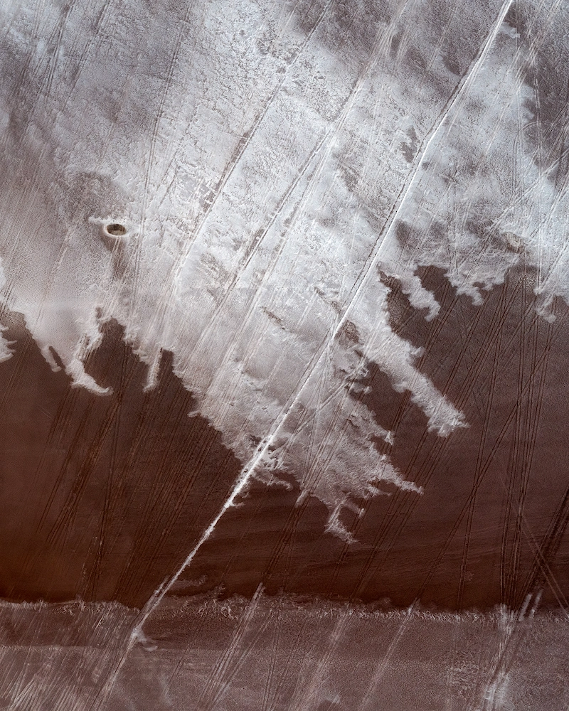 Aerial photography of a landscape with a salt mining with tire tracks in Western Australia