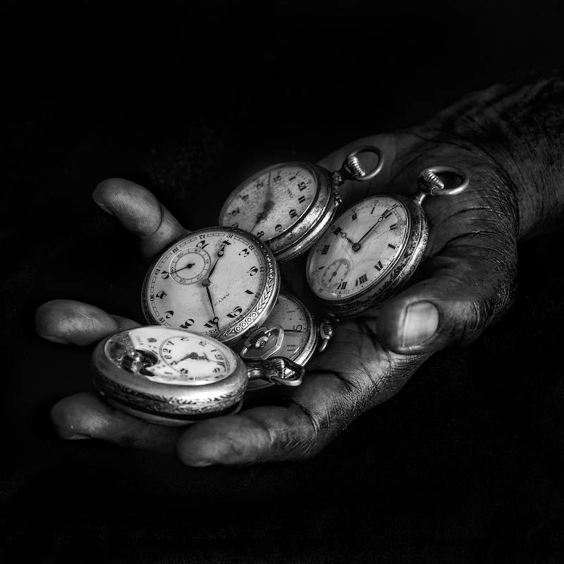 Black hands with pocket watches