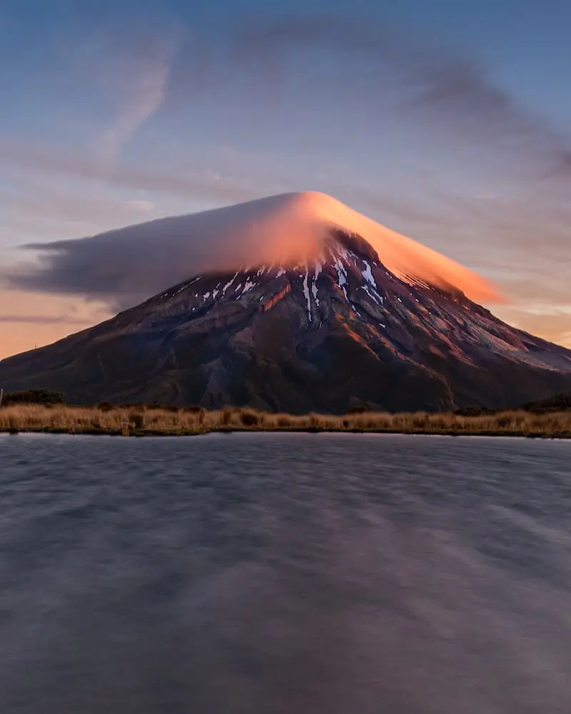 Photography of a mountain with a cloud on the top in Taranaki
