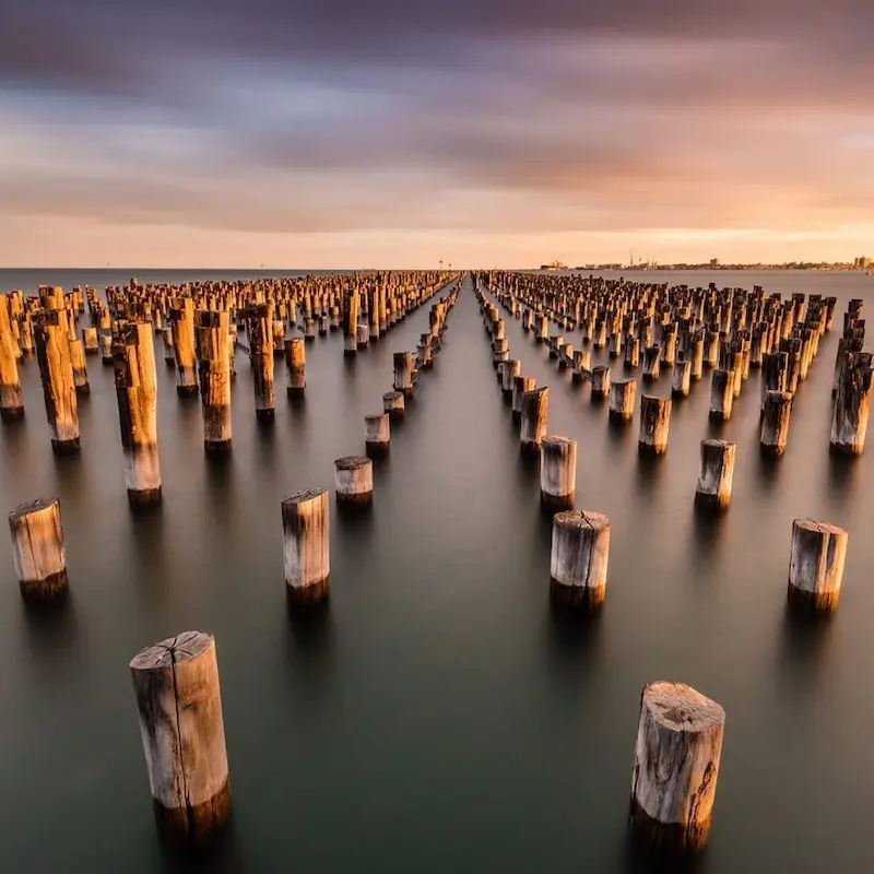 Photographie de pilones inondés dans la mer