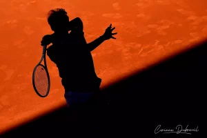 tennis player back-lit by Corinne Dubreuil