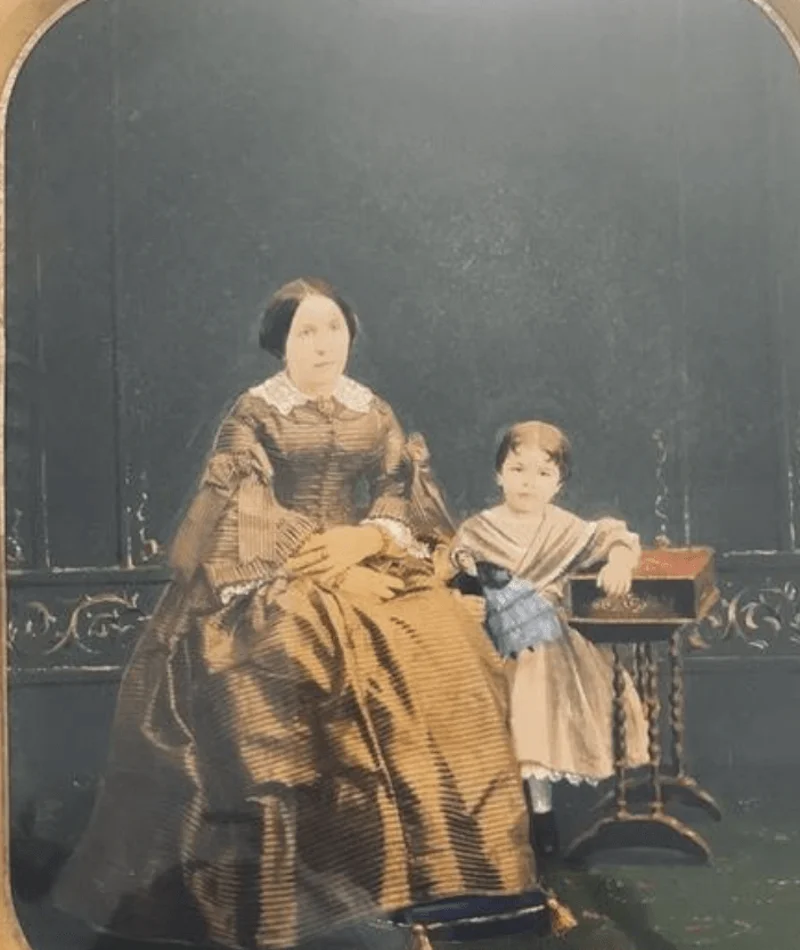 Woman in a dress and a child from 1850