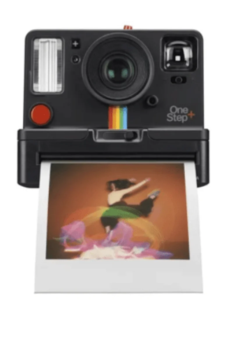 Polaroid camera printing an image of a person dancing