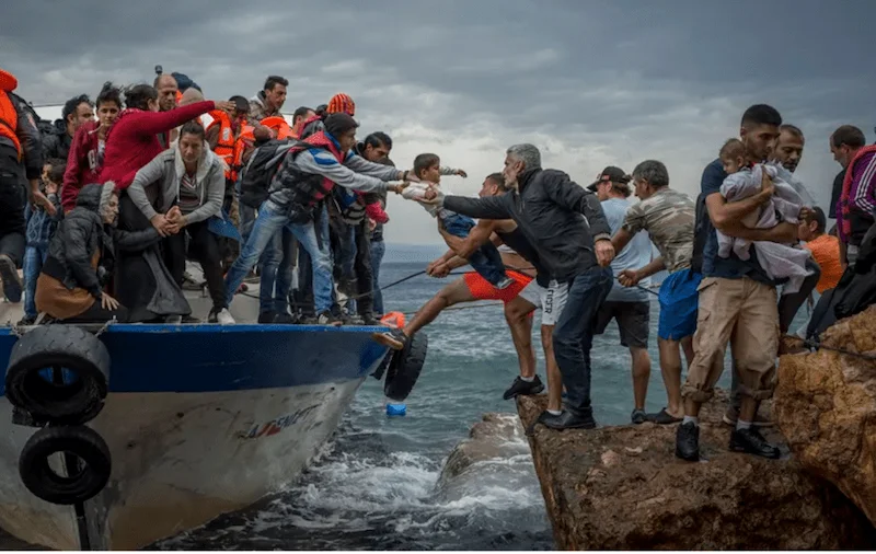Migrants arriving at a coastline, photography representing emotions