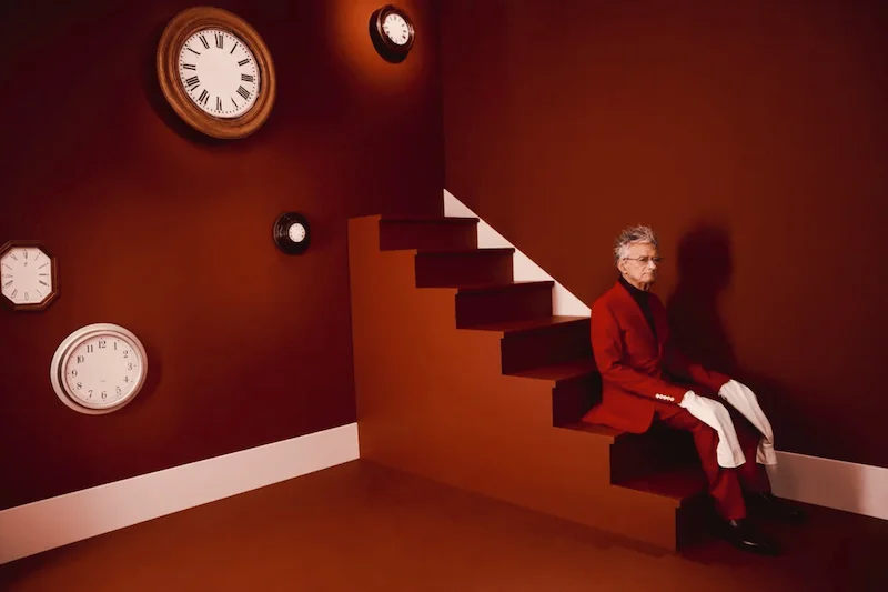 Picture of a man sitting on stairs, red scennery: Charlotte Abramow's work, about social media and photographers, photo retouching and signature