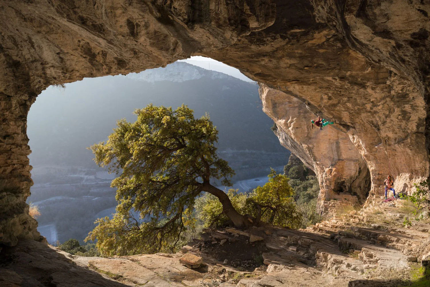 Photography of the view from a mountain with Katherine Choong climbing, taken by Thibaut Marot