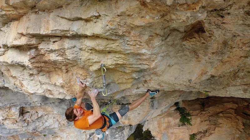 Sebastien Bouin climbing on a cliff