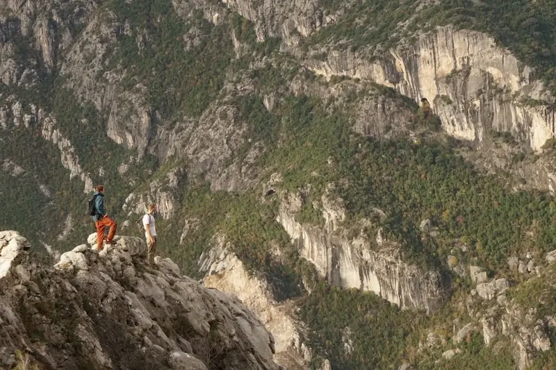 Photography of two men on top of a mountain