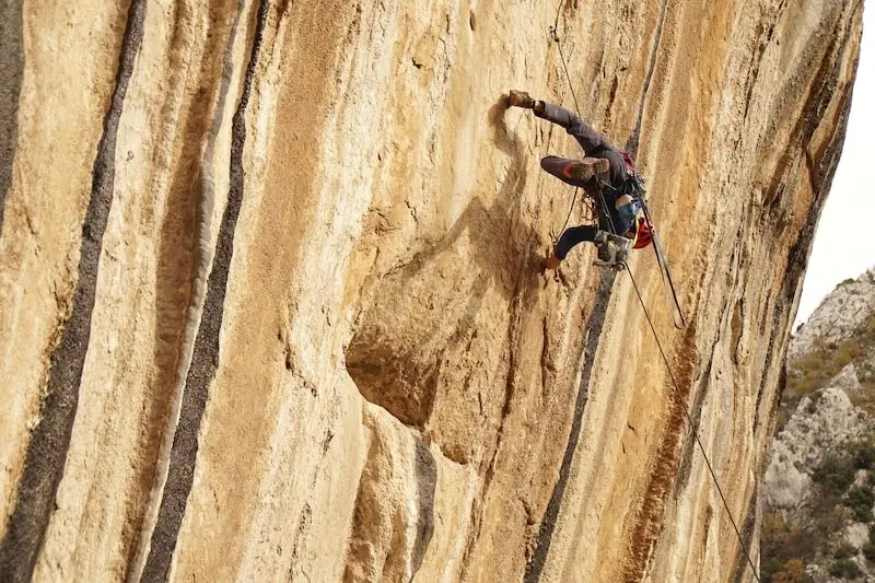 Photography of a man climbing a mountain