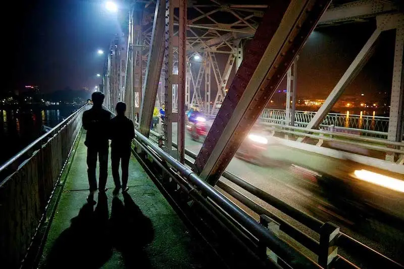 Photography of a bridge with people walking