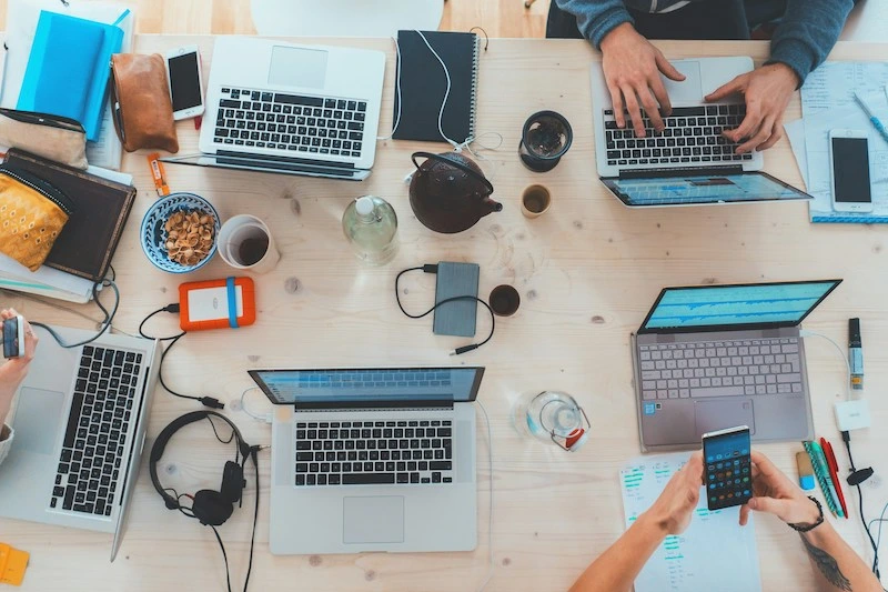 Image of people working on laptop